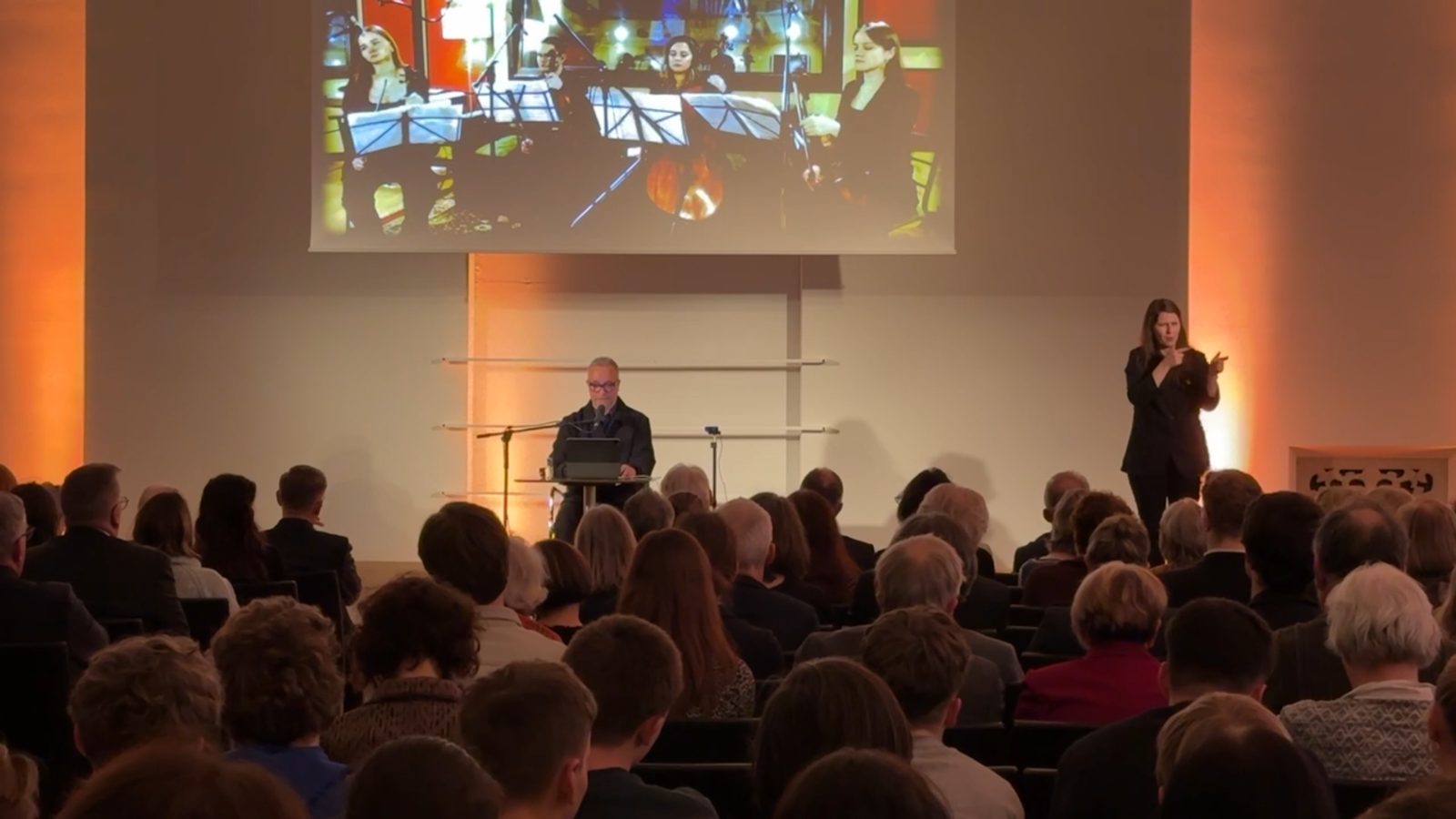 Performance with a sign language interpreter and a string quartet connected live